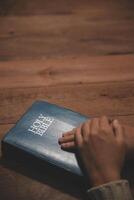 Christian group are praying to god with the bible and sharing the gospel. Concept of faith for god. photo