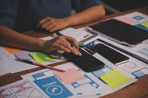 The designer team is designing the uxui system to make the uxui system work well on new phones and support system updates. Website development concept UI UX front end designer photo