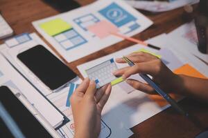 The designer team is designing the uxui system to make the uxui system work well on new phones and support system updates. Website development concept UI UX front end designer photo