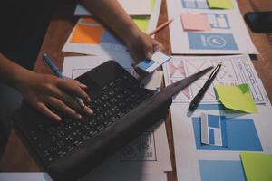 The designer team is designing the uxui system to make the uxui system work well on new phones and support system updates. Website development concept UI UX front end designer photo