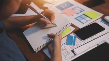 The designer team is designing the uxui system to make the uxui system work well on new phones and support system updates. Website development concept UI UX front end designer photo