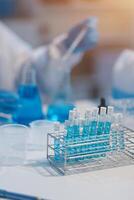 Group of dedicated scientist conduct chemical experiment in medical laboratory, carefully drop precise amount of liquid from pipette into test tube for vaccine drug or antibiotic development. Neoteric photo