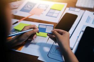 The designer team is designing the uxui system to make the uxui system work well on new phones and support system updates. Website development concept UI UX front end designer photo