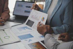 Close up of Business team analyzing income charts and graphs with modern laptop computer. Business analysis and strategy concept. photo
