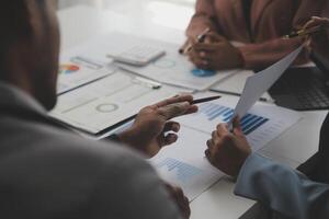 Close up of Business team analyzing income charts and graphs with modern laptop computer. Business analysis and strategy concept. photo
