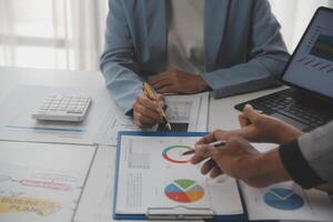 Close up of Business team analyzing income charts and graphs with modern laptop computer. Business analysis and strategy concept. photo