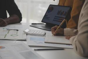 Close up of Business team analyzing income charts and graphs with modern laptop computer. Business analysis and strategy concept. photo
