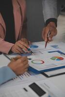 Close up of Business team analyzing income charts and graphs with modern laptop computer. Business analysis and strategy concept. photo