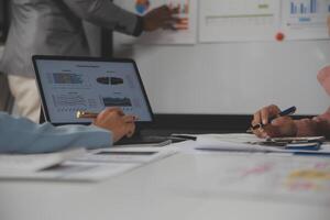 Close up of Business team analyzing income charts and graphs with modern laptop computer. Business analysis and strategy concept. photo