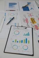 Close up of Business team analyzing income charts and graphs with modern laptop computer. Business analysis and strategy concept. photo
