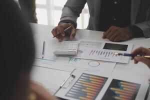 Close up of Business team analyzing income charts and graphs with modern laptop computer. Business analysis and strategy concept. photo