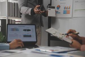 Close up of Business team analyzing income charts and graphs with modern laptop computer. Business analysis and strategy concept. photo