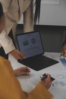 Close up of Business team analyzing income charts and graphs with modern laptop computer. Business analysis and strategy concept. photo