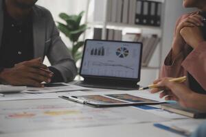 Close up of Business team analyzing income charts and graphs with modern laptop computer. Business analysis and strategy concept. photo