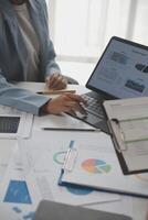 Close up of Business team analyzing income charts and graphs with modern laptop computer. Business analysis and strategy concept. photo