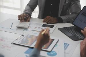 Close up of Business team analyzing income charts and graphs with modern laptop computer. Business analysis and strategy concept. photo
