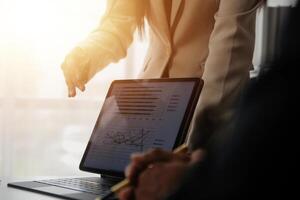 Close up of Business team analyzing income charts and graphs with modern laptop computer. Business analysis and strategy concept. photo