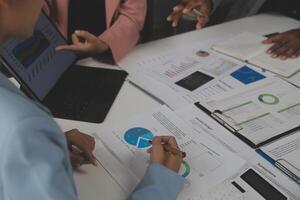 Close up of Business team analyzing income charts and graphs with modern laptop computer. Business analysis and strategy concept. photo