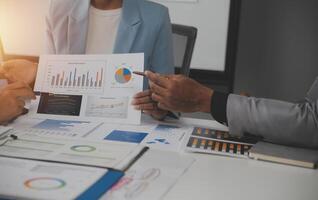 Close up of Business team analyzing income charts and graphs with modern laptop computer. Business analysis and strategy concept. photo