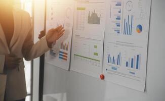 Close up of Business team analyzing income charts and graphs with modern laptop computer. Business analysis and strategy concept. photo