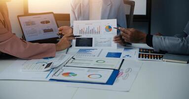 Close up of Business team analyzing income charts and graphs with modern laptop computer. Business analysis and strategy concept. photo