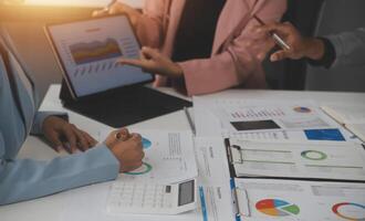 Close up of Business team analyzing income charts and graphs with modern laptop computer. Business analysis and strategy concept. photo