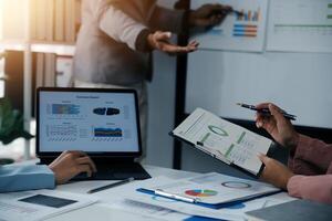 Close up of Business team analyzing income charts and graphs with modern laptop computer. Business analysis and strategy concept. photo
