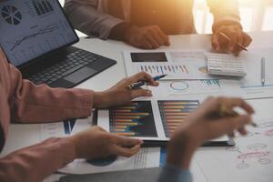 Close up of Business team analyzing income charts and graphs with modern laptop computer. Business analysis and strategy concept. photo