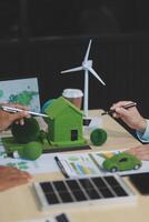 Green energy business company meeting with business people planning and discuss marketing of sustainable and renewable clean energy product with solar cell and wind turbine generator. Trailblazing photo