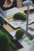 Green energy business company meeting with business people planning and discuss marketing of sustainable and renewable clean energy product with solar cell and wind turbine generator. Trailblazing photo