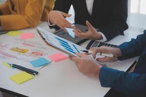 Meeting of business executives discussing analysis of the company's financial situation and business planning with partner collaboration and consultation of strategy. photo