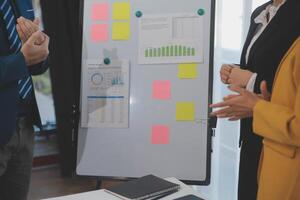 Meeting of business executives discussing analysis of the company's financial situation and business planning with partner collaboration and consultation of strategy. photo