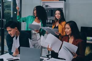 Stress, business people and employee frustrated with multitasking, pressure or overworked by team in chaos with paperwork. Anxiety, headache and worker overwhelmed by group and burnout in crisis photo