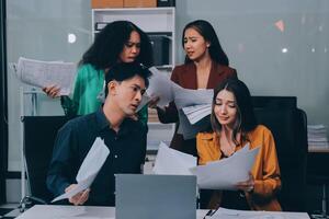 Stress, business people and employee frustrated with multitasking, pressure or overworked by team in chaos with paperwork. Anxiety, headache and worker overwhelmed by group and burnout in crisis photo