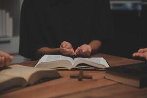 Christian group are praying to god with the bible and sharing the gospel. Concept of faith for god. photo