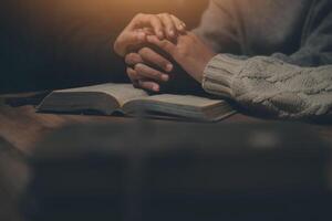Christian group are praying to god with the bible and sharing the gospel. Concept of faith for god. photo