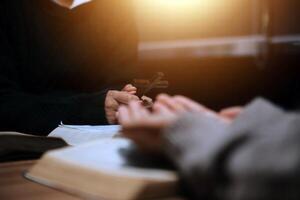 Christian group are praying to god with the bible and sharing the gospel. Concept of faith for god. photo