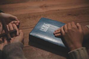 Christian group are praying to god with the bible and sharing the gospel. Concept of faith for god. photo