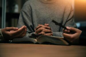 Christian group are praying to god with the bible and sharing the gospel. Concept of faith for god. photo