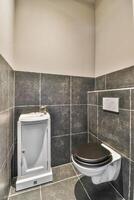 A bathroom with a toilet and a sink photo