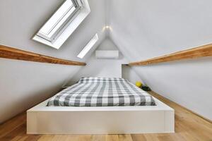 A bedroom with a bed and a window photo