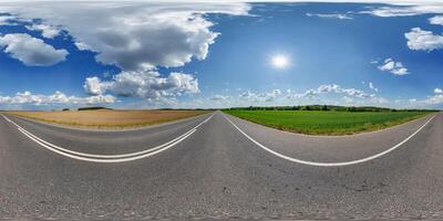 spherical 360 hdri panorama on old asphalt road with clouds and sun on blue sky in equirectangular seamless projection, as skydome replacement in drone panoramas, game development photo