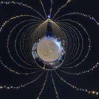 new year tiny planet with Christmas tree. Spherical aerial 360 panorama night view on festive square with illumination in form of tent photo