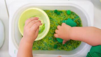 The child develops fine motor skills with the help of a sensor box. video
