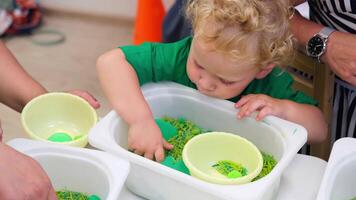 The child develops fine motor skills with the help of a sensor box. video