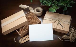 Gift Packaging Boxes Mock Up with Jute String, Thank You and Congratulations Card and Tags with Small Key on Wood Surface. photo