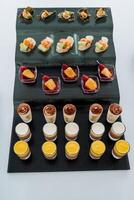 Catering in the office, trifles in a glass, liquid cake in cups top view, beautiful serving of treats to the festive table. photo