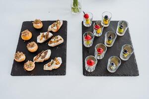 Table setting with snacks in a cup top view, varied menu, food treat in the office, food on a white background. photo