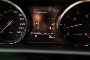 Speedometer in the car, dashboard indicating the speed and revolutions of the car, fuel level sensor in the gas tank, oil temperature in the engine. photo