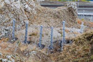 Mesh Separation Fence, Chain-link Mesh, Railway Track, Rockfall Fence in the Mountains. photo